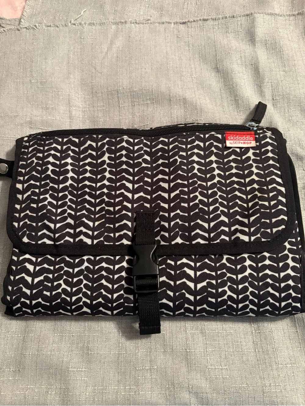 Skidaddle by Skip Hop Black & White Travel diaper bag with fold out changing pad